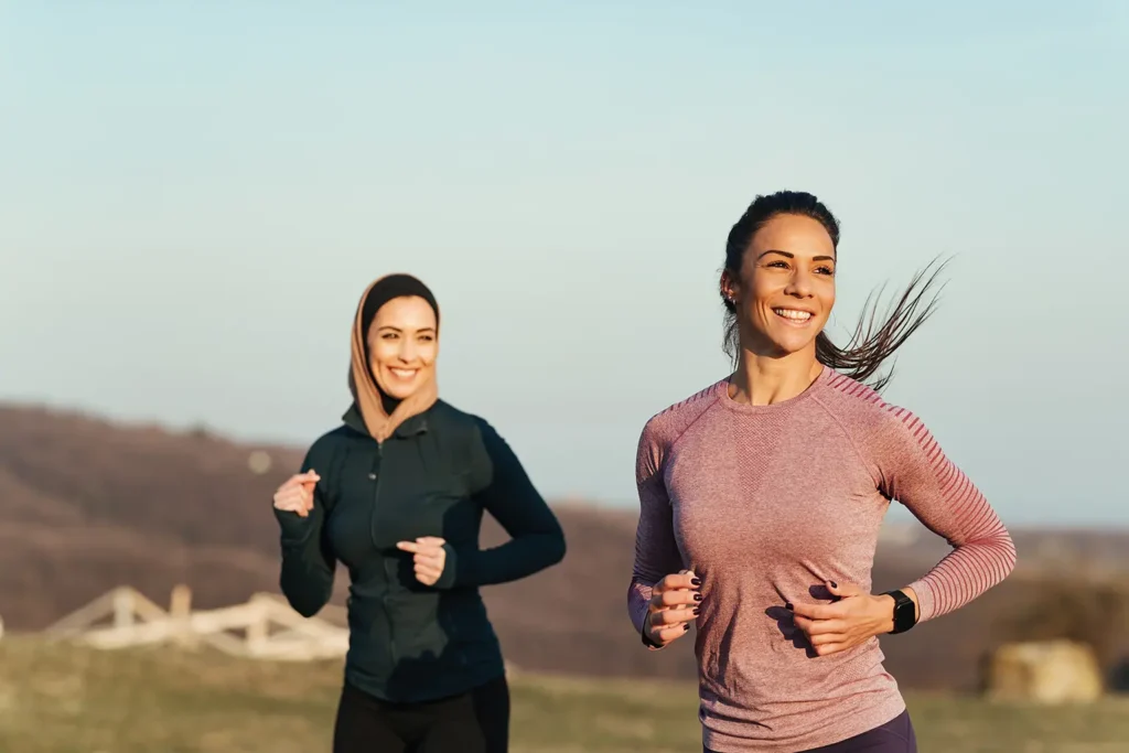 Two women relieving stress and anxiety through exercise, promoting overall well-being and oral health, supported by Montana Center for Implants and Dentures.