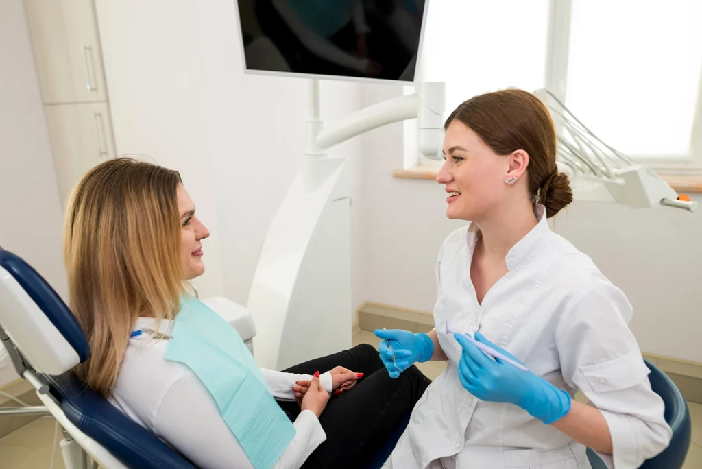 Female dentist consulting with a patient about teeth sensitivity during winter at Montana Center for Implants and Dentures.