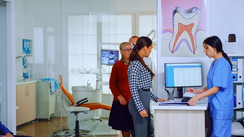 Patients waiting at the reception of a modern dental clinic, where the staff provides information about the most affordable dental implants available at the Montana Center for Implants and Dentures.