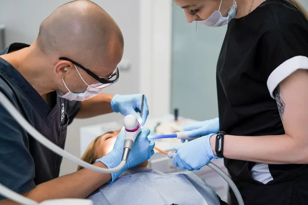 Dentist performing a dental procedure in the first stage of dental implant healing at Montana Center for Implants and Dentures.